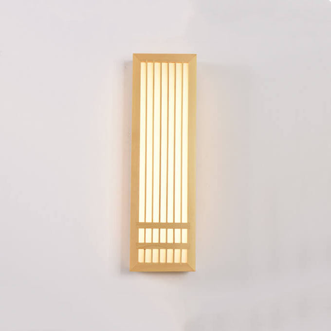 Tall wood wall sconce lit straight on showing vertical slats and glow