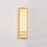 Tall wood wall sconce lit straight on showing vertical slats and glow
