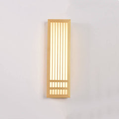 Tall wood wall sconce lit straight on showing vertical slats and glow