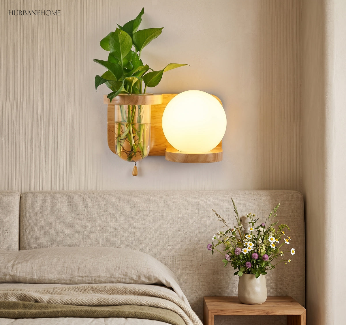 Wood planter sconce lit above a bed with a linen throw