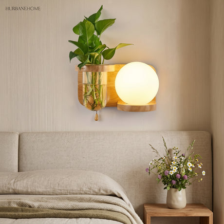 Wood planter sconce lit above a bed with a linen throw