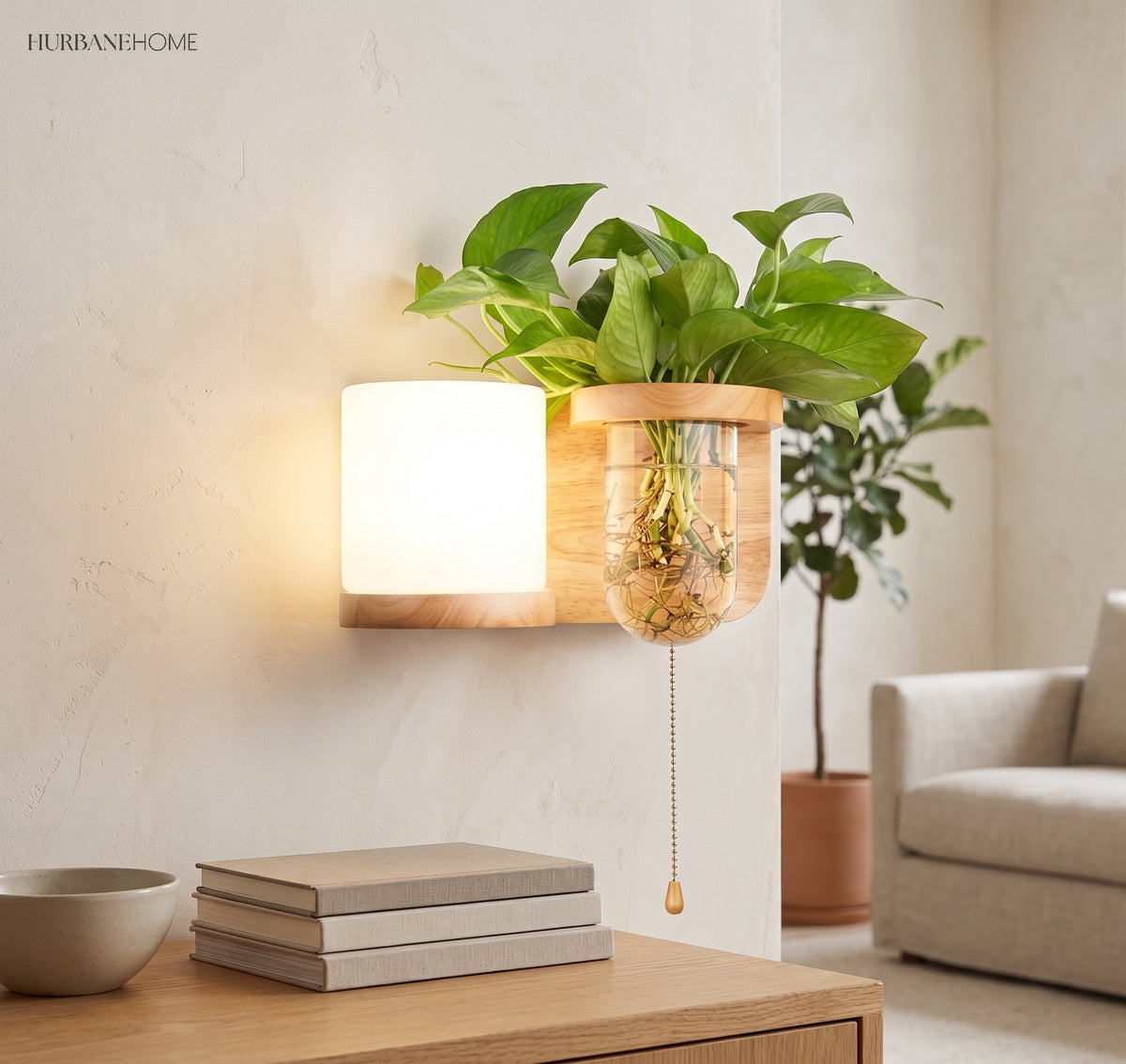 Wood planter sconce lit above a stack of books and a bowl