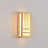 Small wood wall sconce lit at an angle showing its depth and side light