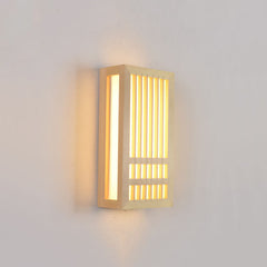Small wood wall sconce lit at an angle showing its depth and side light