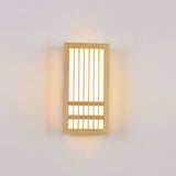 Small wood wall sconce lit straight on with a warm even glow