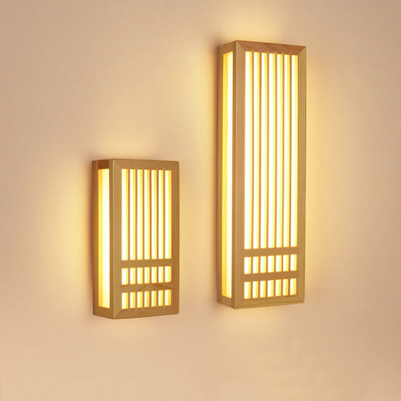 Small and large wood wall sconces shown side by side and lit
