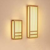 Small and large wood wall sconces shown side by side and lit