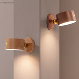 Beech and walnut wooden wall sconces mounted on adjoining plaster walls