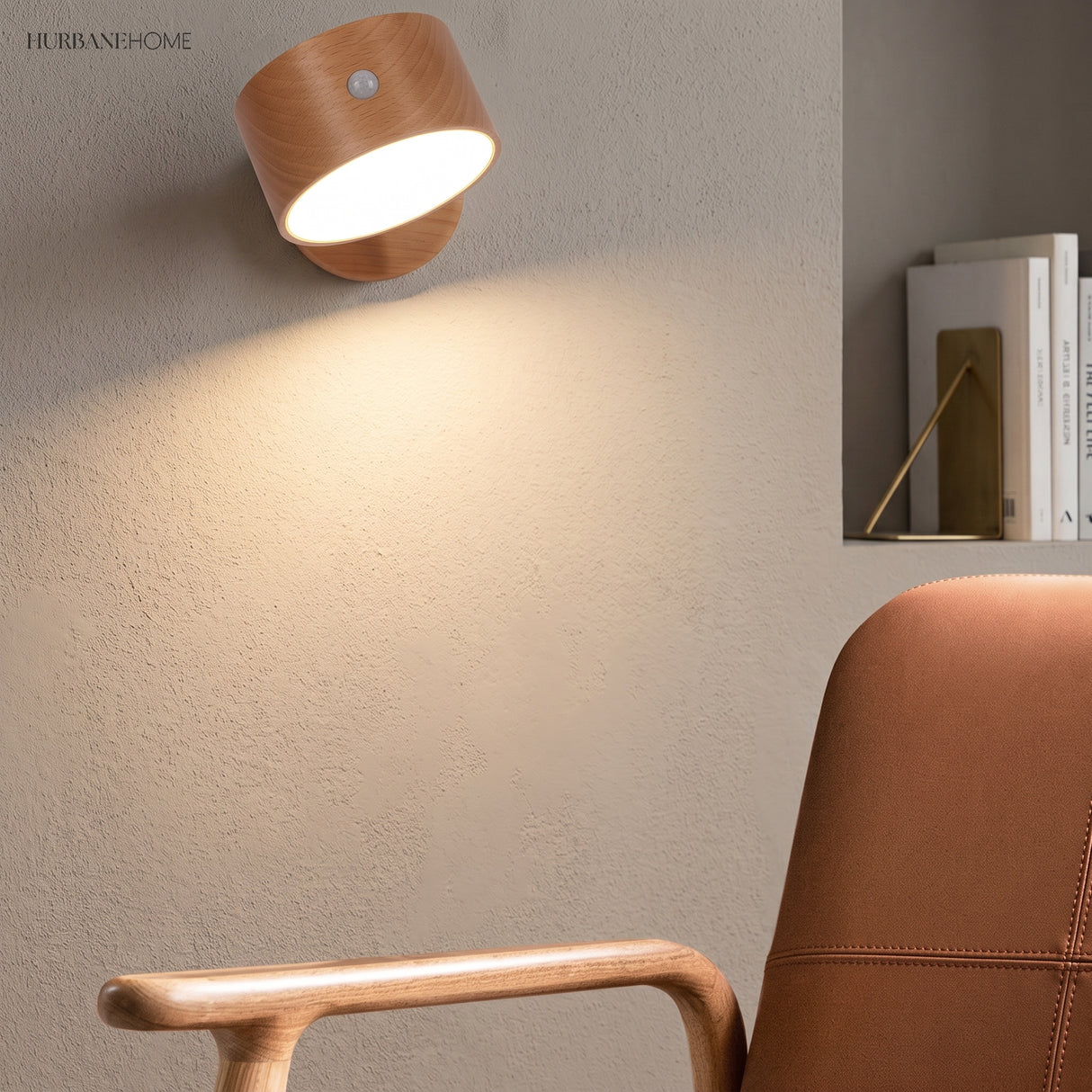 Beech wooden wall sconce above a leather reading chair with books