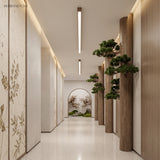Two slim wood grain bar lights lining a bright minimalist corridor