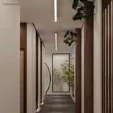 Wood grain linear LED ceiling light running along a long corridor