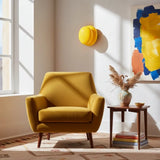Bright yellow glass wall sconce above mustard armchair in sunlit corner