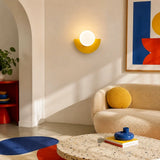Yellow half moon wall sconce viewed from a side angle