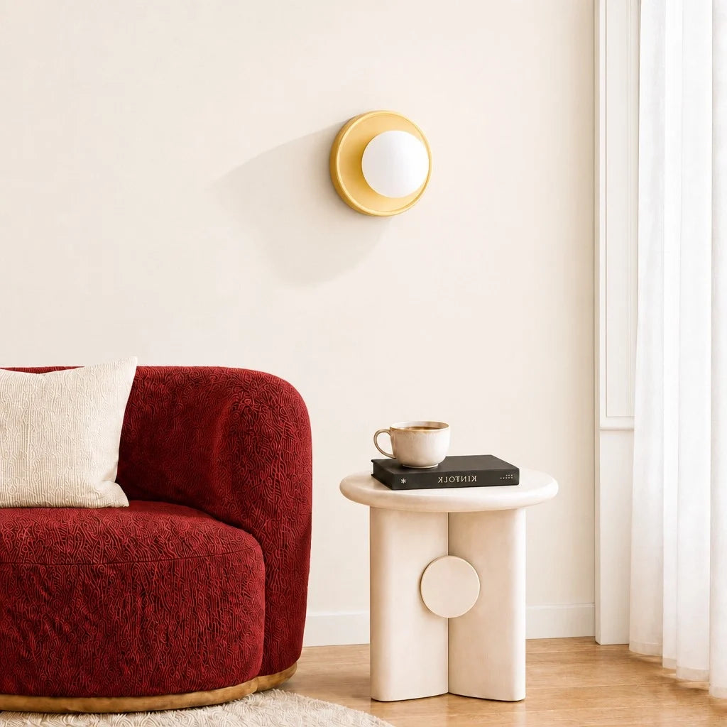 Yellow orb wall sconce angled to show the round backplate and glass globe
