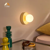 Yellow orb wall sconce shown from the side with a shallow round body