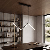 Zigzag linear pendant lit above a dark dining table in a timber lined room